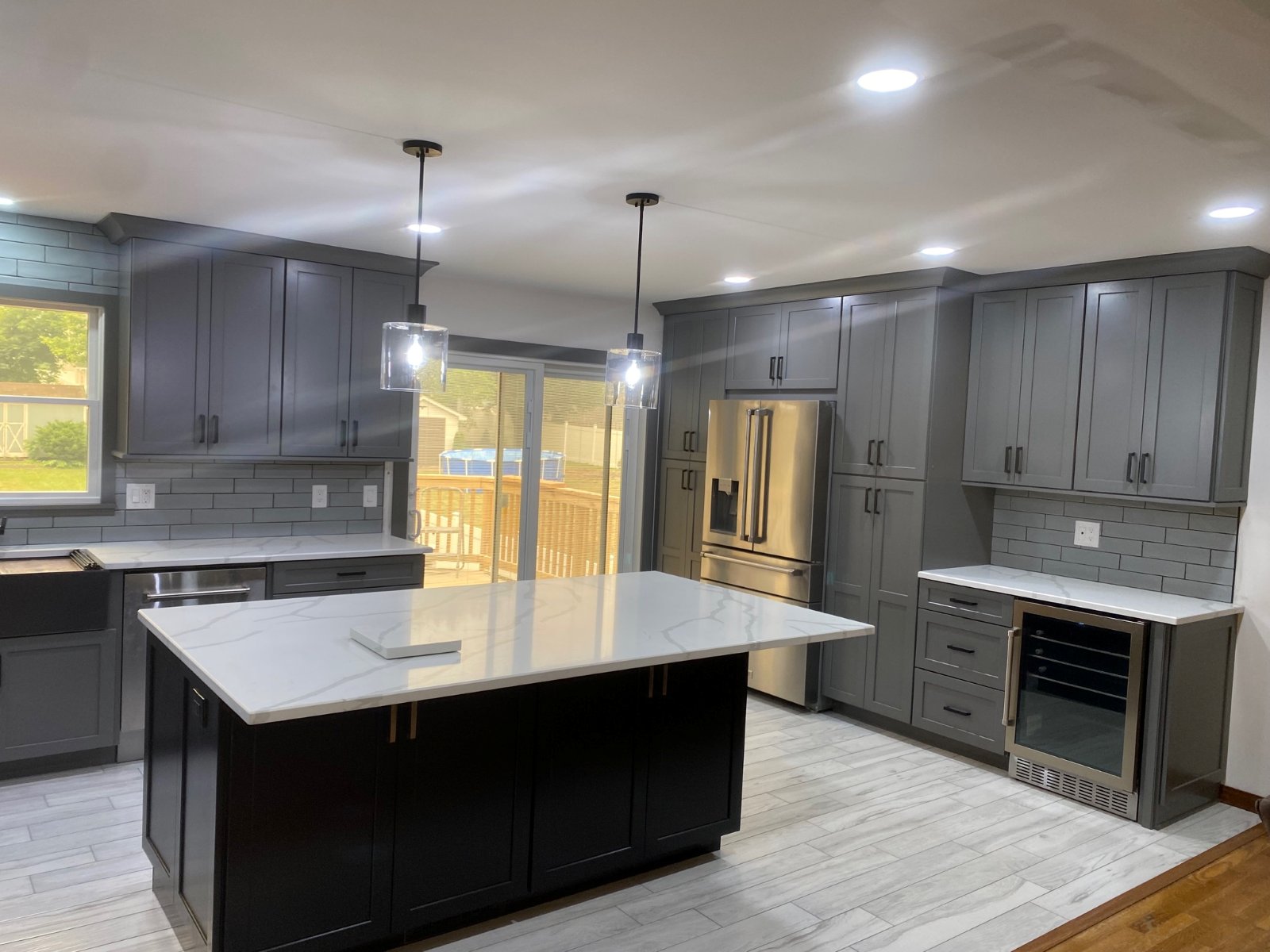 Custom chef's kitchen with waterfall quartz island